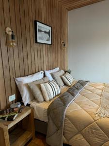 a bedroom with a bed with pillows on it at Suite del muelle in San Carlos de Bariloche