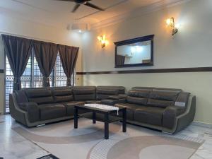 a living room with a couch and a table at Bangi in Kajang