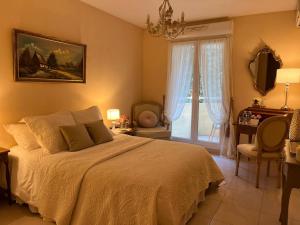 博索莱伊Grace & Breakfast Monaco的一间卧室，里面有一张床、一张桌子和一扇窗户。