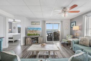 a living room with a couch and a ceiling fan at Lagoon Landing 207- Best of beach & lagoon in Gulf Shores