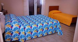 a bedroom with a bed with a blue comforter at Casa Nenè in Trabia