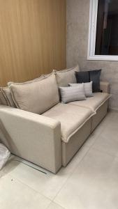 a large couch sitting in a room at apartamento em prédio de luxo in Santo André