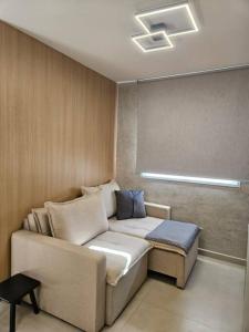 a living room with a couch and a table at apartamento em prédio de luxo in Santo André