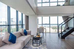 a living room with a couch and a table at Grand La Vogue Hotel and Casino in Sihanoukville