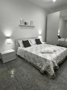 a bedroom with a large bed with two towels on it at Black Daisy in Bernalda
