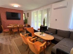 a living room with a couch and a table at Tágas hely a parton in Balatonszárszó