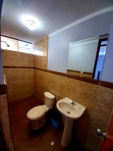 a bathroom with a toilet and a sink at Hospedaje D Francisco in Lima