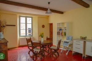 a kitchen and dining room with a table and chairs at Chapitre des Chanoines in Entrevaux