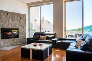 a living room with a couch and a fireplace at Entregredos in Guisando