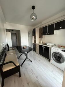 a living room with a table and a kitchen at Apartment 2 camere 1,3 km Promenada Mall Capacitate 4 persoane in Craiova