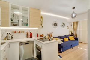 Il comprend une cuisine et un salon avec un canapé bleu. dans l'établissement Esther Dream Bungalow, à Mogán