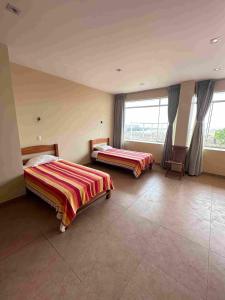 Postel nebo postele na pokoji v ubytování YOLO House Peru