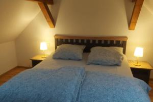 a bedroom with a bed with two pillows and two lamps at Ferienwohnung Gisela 80qm in Gernrode - Harz
