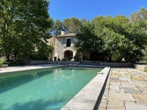 a swimming pool in front of a house at MAS DES CIGALES Lambesc in Lambesc