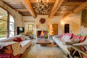 a living room with couches and a fireplace at MAS DES CIGALES Lambesc in Lambesc