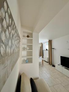 a living room with a couch and a television at Villa Serena in Monopoli