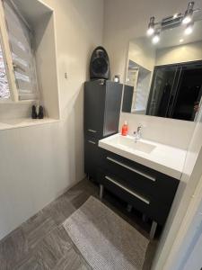 a bathroom with a sink and a mirror at Étape lembronnaise in Saint-Germain-Lembron
