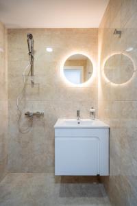 a bathroom with a white sink and a mirror at Fusion Finesse in Sofia