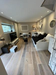 a living room with a couch and a table at Le Passage Secret in Fleury-en-Bière