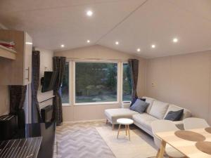a living room with a white couch and a window at Chalet in Makkum - K118 in Makkum