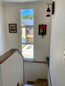 a stairway with a window and a stair case at Casa completa en Pucón - Refugio Natural para 6 Personas in Pucón +18 photos