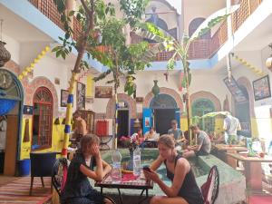 two women sitting at a table in a restaurant at Riad Dia in Marrakesh
