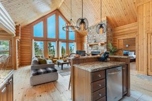 a kitchen and living room in a log cabin at Fiddler Lake Resort - Deer 87 in Mille-Isles +31 photos