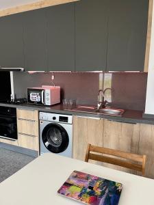 a kitchen with a sink and a washing machine at Cyprus Chill Apartment in İskele