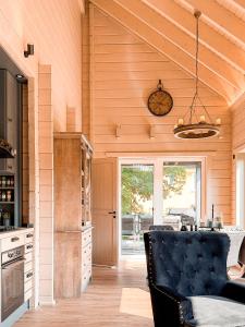 a kitchen with a black leather chair in a room at Hercynia Lodge in Bad Lauterberg