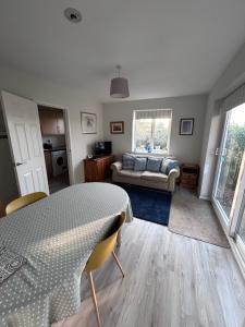 a living room with a table and a couch at Hamble House Holiday Let in Woodbridge
