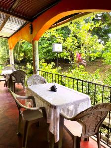 a table and chairs sitting on a porch with at El Mexican in Moyogalpa +42 photos