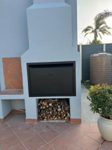 a tv sitting on top of a wall with a fire place at The Starling Room in East London