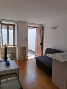 a bedroom with a bed and a desk with a computer at Porto Histórico - pet friendly in Porto