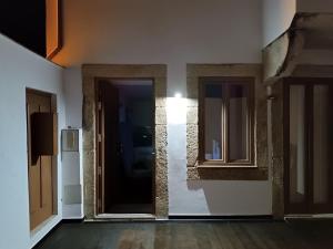 an empty room with a door and two windows at Porto Histórico - pet friendly in Porto