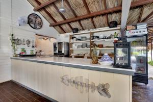 a kitchen with a counter with a clock on the wall at Red Palm Village in Kralendijk