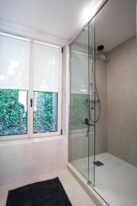 a glass shower in a bathroom with a window at Les Ailes du moulin in Ault +61 photos