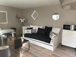 a living room with a couch and a table at Le Passage Secret in Fleury-en-Bière