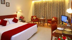 Postel nebo postele na pokoji v ubytování Sangam Hotel, Thanjavur