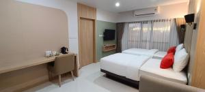 a hotel room with a bed and a desk with a computer at Bangkok Mystay Hotel Rangsit in Thanya Buri +160 photos