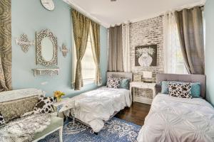 a bedroom with two beds and a mirror at Spacious Historic Home with Yard and Deck! in High Point