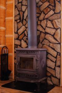 a fireplace in a room with a stone wall at Uroczy domek w Rabce-Zdrój in Rabka-Zdroj +31 photos