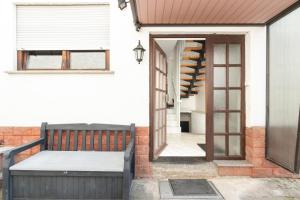 a house with a balcony with a door and a staircase at Arbeitnehmerunterkunft I 3 Betten I Balkon I eigene Küche & Bad in Groß-Umstadt