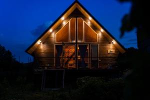 a house with lights on the front at night at Edgar's House in Bnunis +9 photos