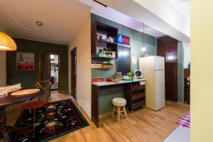 a kitchen with a table and a refrigerator at Alba House in Alba Iulia