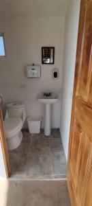 a bathroom with a toilet and a sink at Cabañas Tres Soles in Xico +3 photos