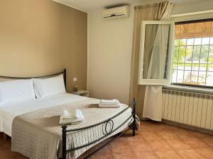 a bedroom with a bed and a window at Anna House in Fiumicino