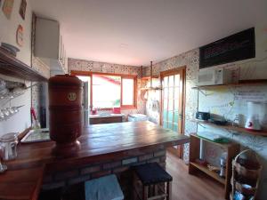 a kitchen with a wooden counter top in a room at Hospedagem Maria de Liu in Palmeiras