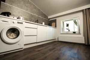 pralnia z pralką i oknem w obiekcie TS Apartamenty w Bydgoszczy