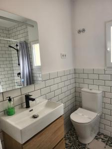 a white bathroom with a sink and a toilet at Viviendas plaza del tronco 2 in Ferrol +29 photos