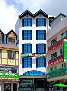 a large white building with windows on the side of it at Hotel Rainbow in Cameron Highlands